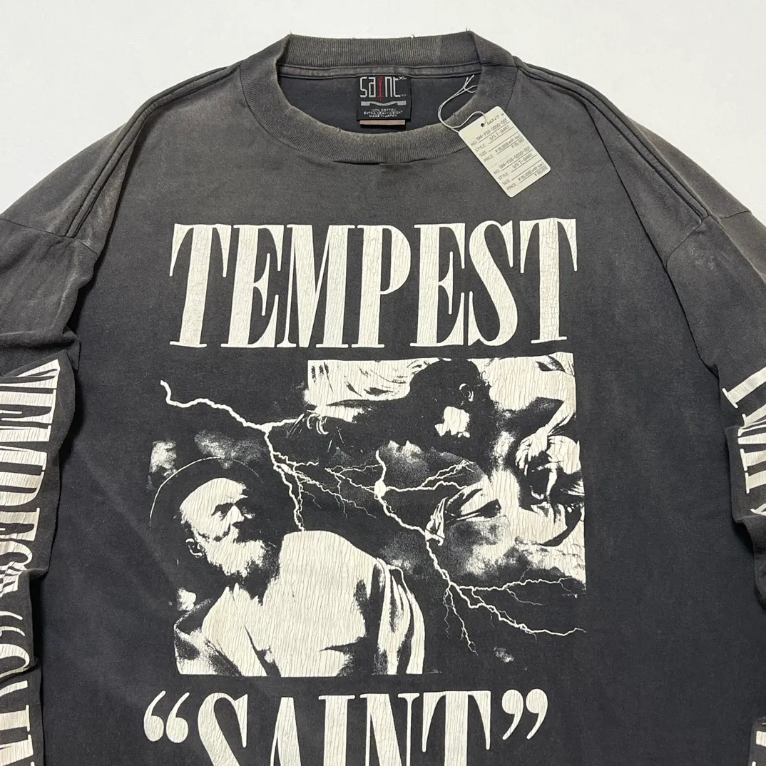 SAINT Mxxxxxx LS TEE/TEMPEST/BLK 'TEMPEST SAINT' Storm Religious Saints Cracked Retro Vulcanized Heavy Wash Long Sleeves Washed Black S-XL Assute Dyeing Multi-bit Horse Fading Craftsmanship Grinding and Hanging Holes Full of Old Feeling Top Printing Craftsmanship Purchasing Level